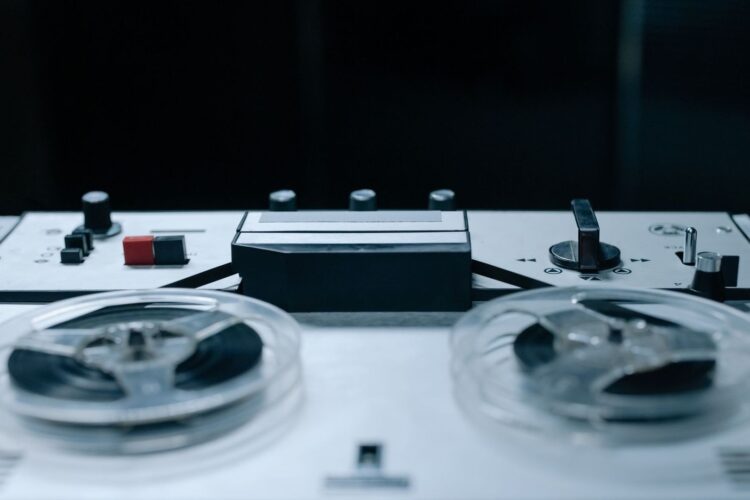 Close-up of a vintage reel-to-reel tape recorder with two reels