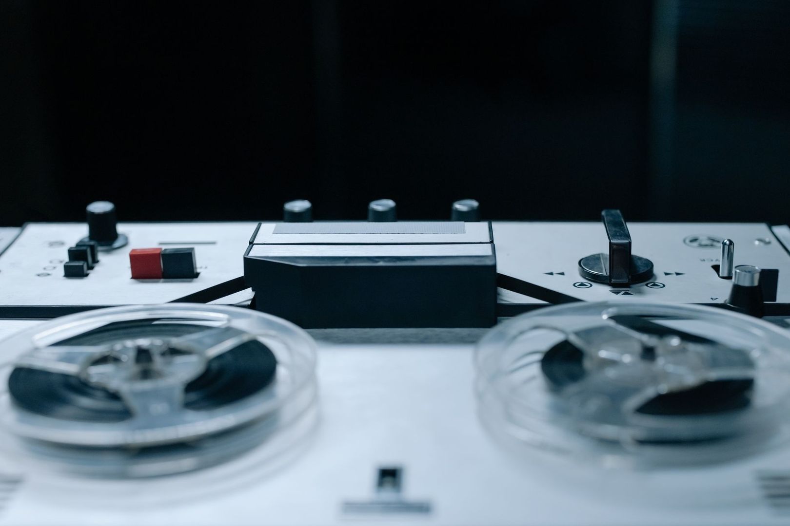 Close-up of a vintage reel-to-reel tape recorder with two reels